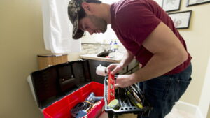 Plumber checking his level and toolbox on a bathroom job